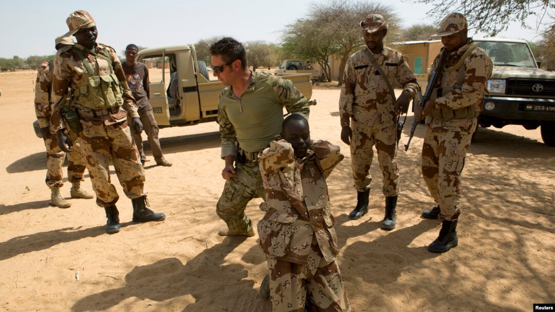 FILE - A U.S. special forces soldier demonstrates how to detain a suspect during Flintlock 2014, a U.S.-led international training mission for African militaries, in Diffa, March 4, 2014.
