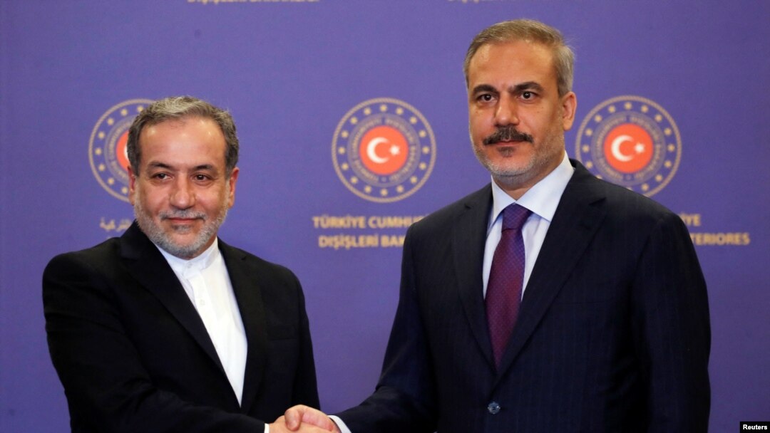 Iranian Foreign Minister Abbas Araqchi, left, shakes hands with his Turkish counterpart, Hakan Fidan, during a joint press conference in Istanbul on Oct. 19, 2024.