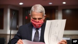 FILE - Dr. Anthony Fauci, director of the National Institute for Allergy and Infectious Diseases, prepares to testify before a Senate hearing on Capitol Hill, June 30, 2020.