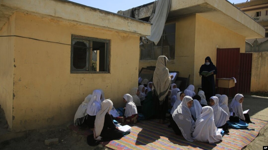 FILE - in this Wednesday, Oct. 7, 2020, students attend an open air class at a primary school in Kabul, Afghanistan. An Afghan education ministry memo banning girls from singing at public school functions received a lot of attention recently. (AP Photo/Mariam Zuhaib, File)