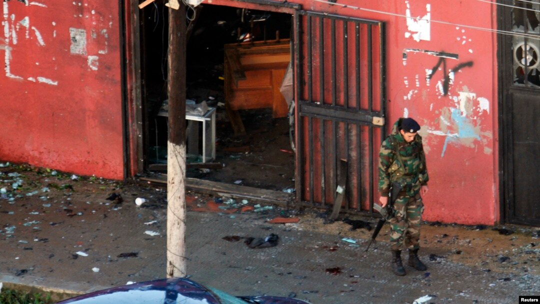 A Lebanese Army soldier guards a cafe where a suicide bomb attack took place in Jabal Mohsen, Tripoli, Jan. 11, 2015.