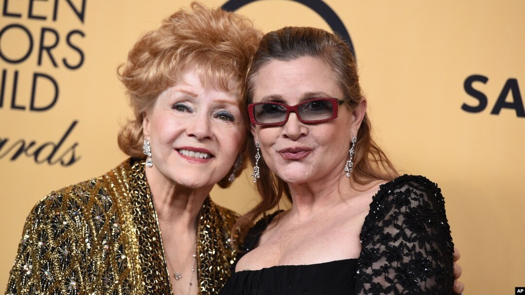Debbie Reynolds, winner of the Screen Actors Guild lifetime award, left, and Carrie Fisher pose in the press room at the 21st annual Screen Actors Guild Awards at the Shrine Auditorium, Jan. 25, 2015, in Los Angeles. 
