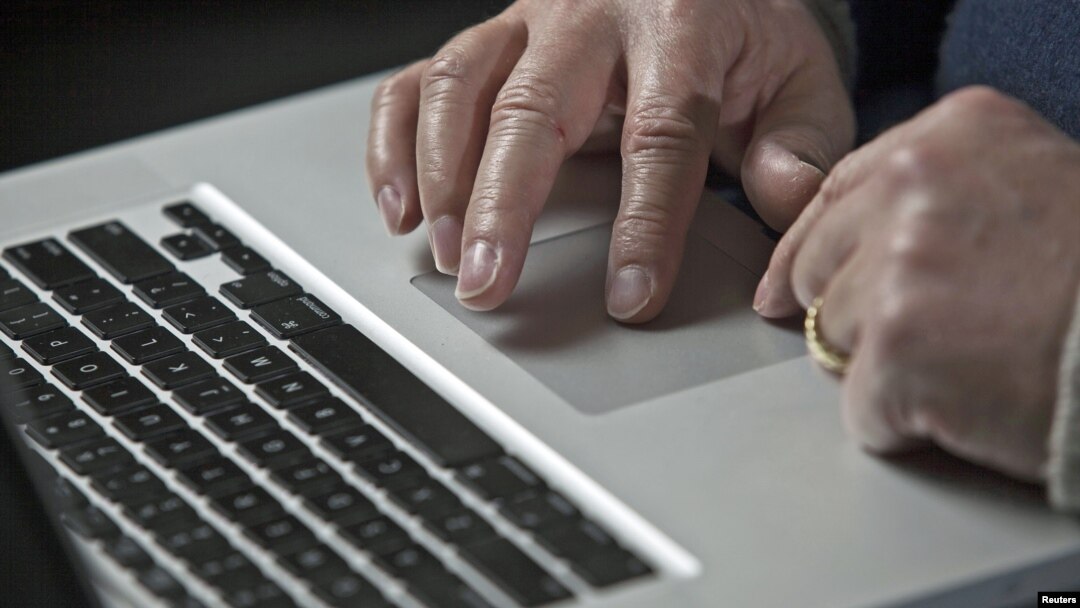 FILE - A cybersecurity expert works on his laptop computer in Charlotte, North Carolina, USA.