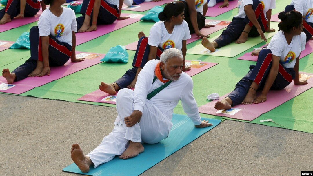 India's Prime Minister Narendra Modi participates in a yoga session to mark International Day of Yoga, in New Delhi, India, June 21, 2015. Modi led tens of thousands of people in the yoga session in the centre of the capital on Sunday to showcase the country's signature cultural export, which has prompted criticism of fomenting social divisions at home. 