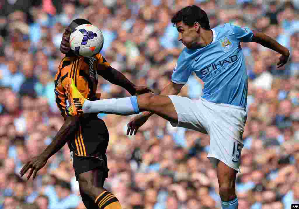Manchester City's Spanish midfielder Jesus Navas vies with Hull City's Honduran defender Maynor Figueroa (L) during the English Premier League football match between Manchester City and Hull City at Etihad Stadium in Manchester, northwest England. Manchetser City won the game 2-0.