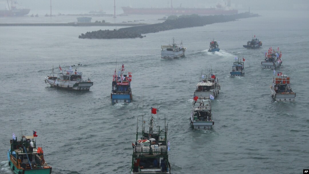 FILE - Several dozen fishing boats flying Taiwanese national flags set out from the Suao harbor, northeastern Taiwan, Sept. 24, 2012.