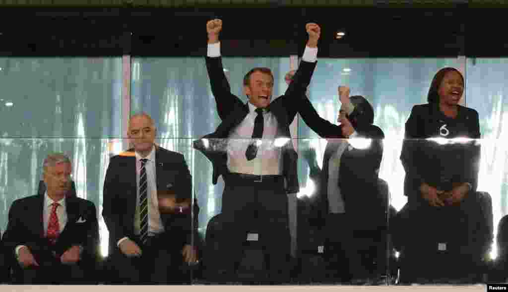 French President Emmanuel Macron (C) celebrates France's victory over Belgium during the semifinal match between the two teams at the 2018 soccer World Cup at the St. Petersburg Stadium in St. Petersburg, Russia, as King Philippe of Belgium (L) looks on, July 10, 2018.