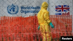 FILE - A person dressed in Ebola protective apparel is seen inside an Ebola care facility at the Bwera general hospital near the border with the Democratic Republic of Congo in Bwera, Uganda, June 14, 2019. 