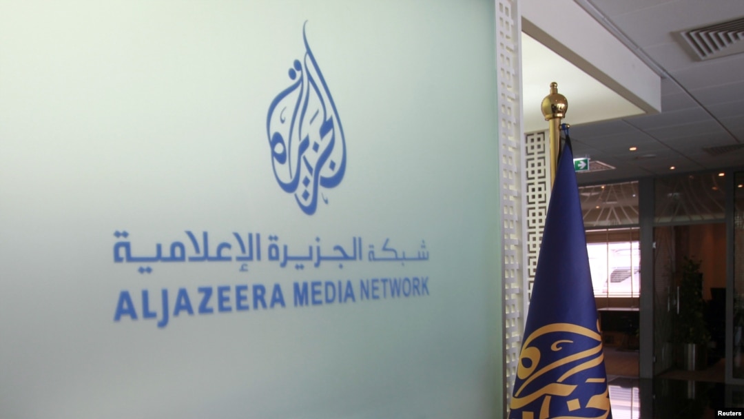 FILE - The Al Jazeera Media Network logo is seen inside its headquarters in Doha, Qatar, June 8, 2017. 
