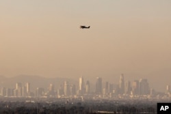 Haze from various wildfires hangs over the downtown skyline, Sept. 11, 2024, in Los Angeles.