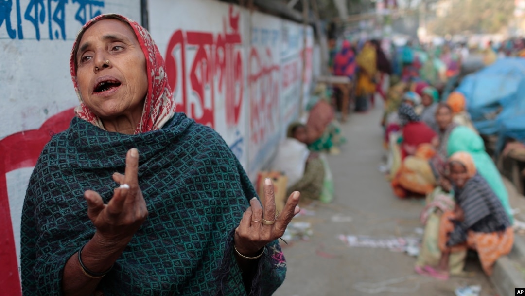 FILE - Anwara, 55, a Bangladeshi daily wage laborer who earns less than $4 per day, laments the lack of work due to the political unrest as she awaits work by a roadside during the second day of a 72 hours long strike called by the opposition Bangladesh National Party.