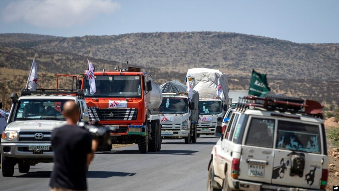 FILE - A convoy of trucks from Doctors Without Borders carrying medical supplies stops by the side of the road after receiving news that the road ahead has been closed by the Ethiopian military, in the Tigray region of northern Ethiopia, May 8, 2021.