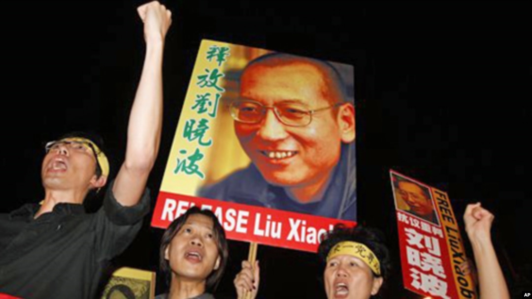 Pro-democracy protesters raise pictures of Chinese dissident Liu Xiaobo with Chinese words reading: ‘Release Liu Xiaobo’ during a demonstration outside the China's Liaison Office in Hong Kong, 08 Oct. 2010