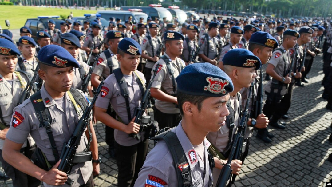 Members of Indonesian National Police elite unit "Mobile Brigade" stand in attention during a security show of force ahead of Christmas and New Year celebrations at the National Monument in Jakarta, Indonesia, Thursday, Dec. 22, 2016.