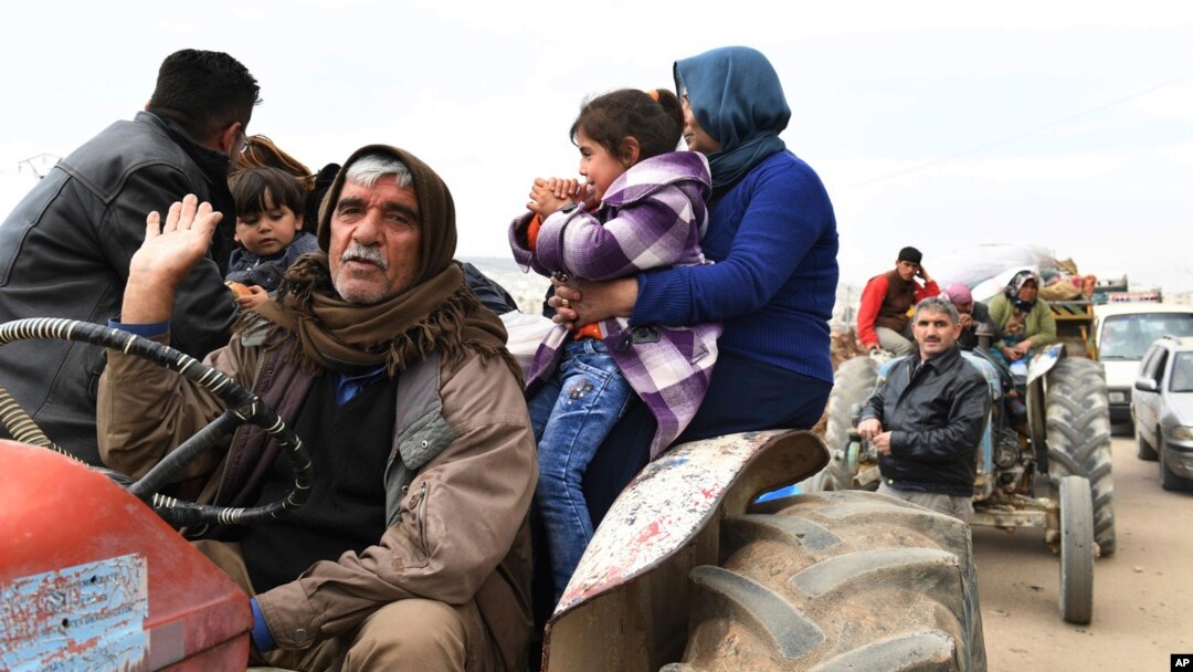 This photo released on March 7, 2018 by the Syrian official news agency SANA, shows Kurds fleeing from their villages where Turkish forces and Syrian rebels battle against Kurdish fighters, in Afrin, northern Syria. 