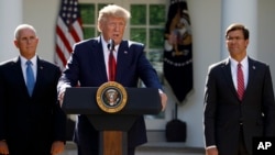 President Donald Trump, with Vice President Mike Pence and Defense Secretary Mark Esper, speaks at a U.S. Space Command ceremony, in Washington, Aug. 29, 2019. He began by saying he'd cancel a trip abroad to monitor preparations for Hurricane Dorian.