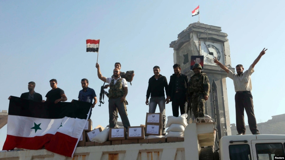 Fighters celebrate after Syrian government forces and their Hezbollah allies capture the key town of Qusair, June 5, 2013. 