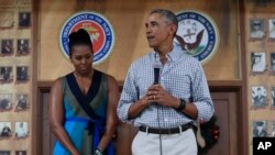 President Barack Obama, joined by first lady Michelle Obama, speaks during an event to thank service members and their families at Marine Corps Base Hawaii, in Kaneohe Bay, Hawaii, Dec. 25, 2016.