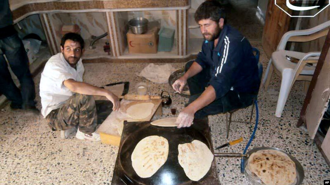 Syrian rebels make bread in the town of Qusair, Homs province, Syria. The UN is stepping up food deliveries in Syria ahead of the early July start of the Islamic holy month of Ramadan, June 3, 2013.