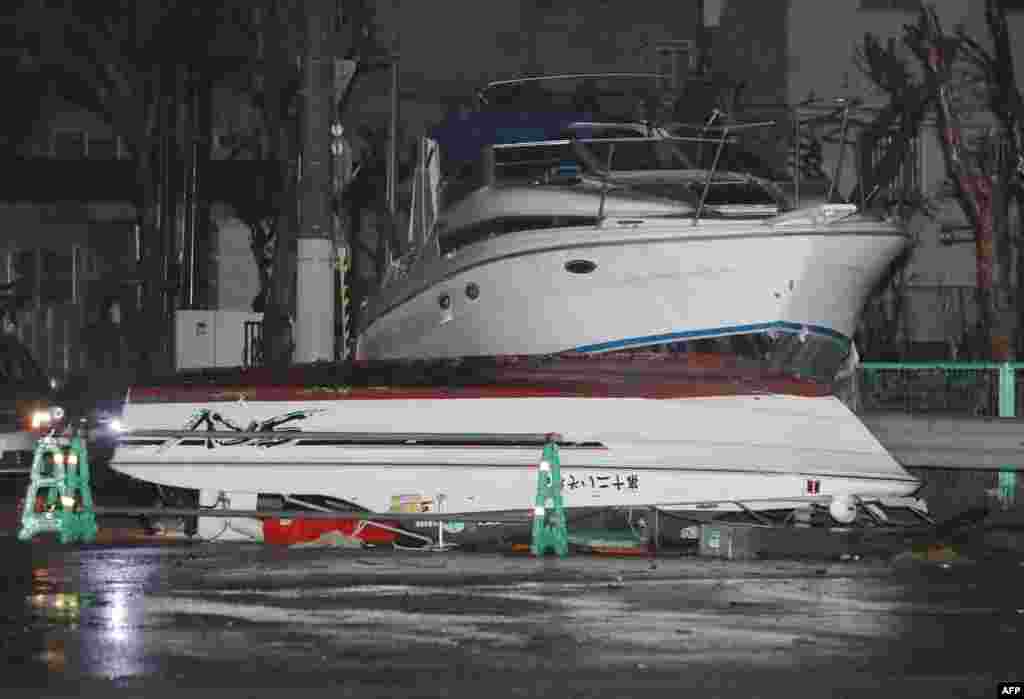 Boats lie on a street after being carried by storm surge caused by typhoon Jebi in Nishinomiya, Hyogo prefecture. The strongest typhoon hit Japan in 25 years battered the west of the country with violent winds and heavy rain, killing six and injuring scores more. Powerful gusts ripped sheeting from rooftops, overturned trucks on bridges and swept a tanker anchored in Osaka Bay into a bridge to Kansai International Airport.