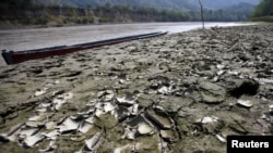 FILE - An area is uncovered by the lowering of the water level in the Magdalena river, the longest and most important river in Colombia, due to the lack of rain, in the city of Honda, Colombia Jan. 14, 2016. 