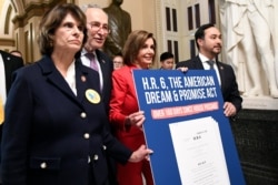 House Speaker Nancy Pelosi. second from right, joined by, from left, Rep. Lucille Roybal-Allard, Senate Minority Leader Sen. Chuck Schumer, and Rep. Joaquin Castro, carry a sign as they walk on Capitol Hill, Nov. 12, 2019.