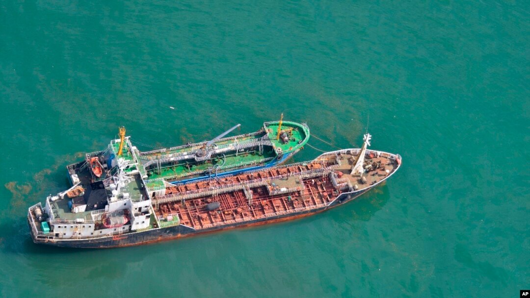 FILE - This May 24, 2018, photo released by Japan's Ministry of Defense shows North Korean-flagged tanker SAM JONG 2, bottom, alongside MYONG RYU 1, a vessel of unknown nationality, in the East China Sea. Japan's Foreign Ministry said a Japanese navy surveillance aircraft spotted a suspected unidentified ship apparently transferring fuel to a North Korean tanker in the open seas.